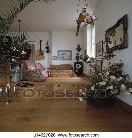 Stock Photo - Split-level living room with wooden floor with storage drawers . Fotosearch