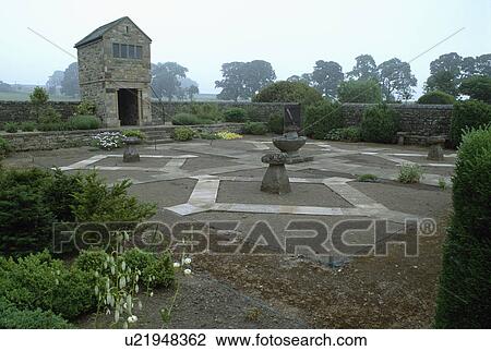 Stock Image - Staddlestones in formal garden before planting. Fotosearch