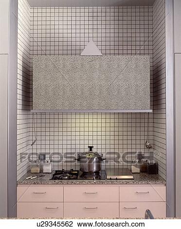 Steel pan on gas hob set into pink kitchen unit in white tiled recess View Large Photo Image Stock Image - Steel pan on gas hob set into pink kitchen unit in white tiled recess. Fotosearch