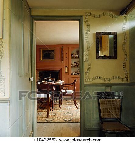 Stencilled wall above pastel green dado in small hall with open door and view of dining room View Large Photo Image Stock Image - Stencilled wall above pastel green dado in small hall with open door and view of dining room. Fotosearch