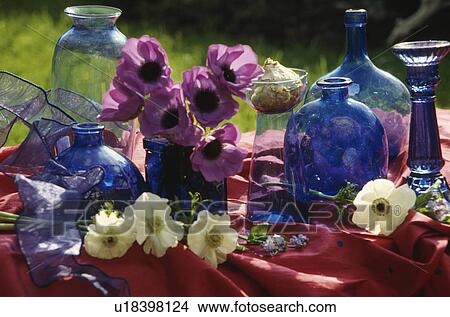Picture - Still-life of blue glass bottles and anemones&#13; &#10;. Fotosearch