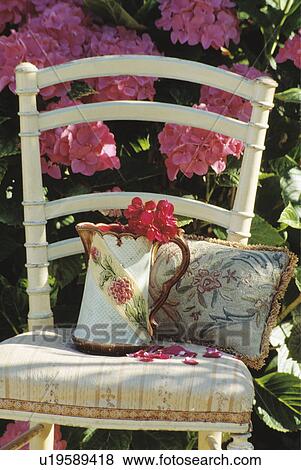 Stock Photo - Still-Life of chair and pink hydrangeas. Fotosearch