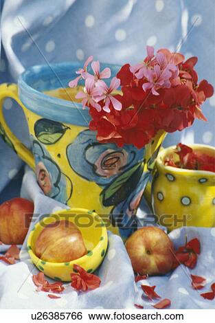 Stock Photograph - Still-Life of colourful pottery and red geraniums. Fotosearch