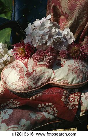 Stock Photograph - Still-Life of flowers and red+white fabric. Fotosearch