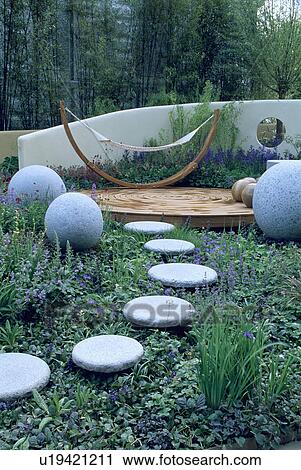 Stock Image - Stone balls in modern garden. Fotosearch