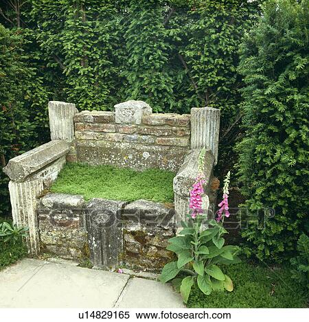 Stock Photography - Stone bench with camomile seat in country garden&#13; &#10;. Fotosearch