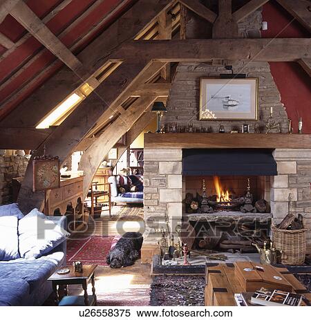 Stone fireplace in barn conversion living room with beamed ceiling and oak crossbars View Large Photo Image Stock Photography - Stone fireplace in barn conversion living room with beamed ceiling and oak crossbars. Fotosearch