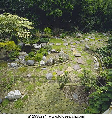 Stone paving in green Japanese-style garden View Large Photo Image Stock Image - Stone paving in green Japanese-style garden. Fotosearch