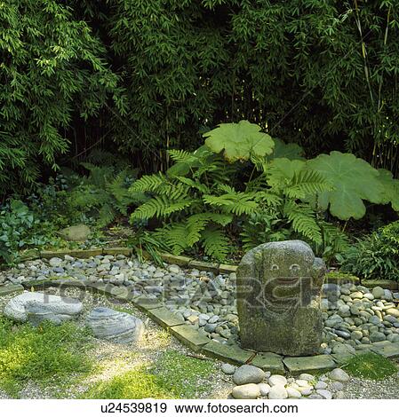 Stone sculpture in green Japanese-style garden View Large Photo Image Stock Photo - Stone sculpture in green Japanese-style garden. Fotosearch