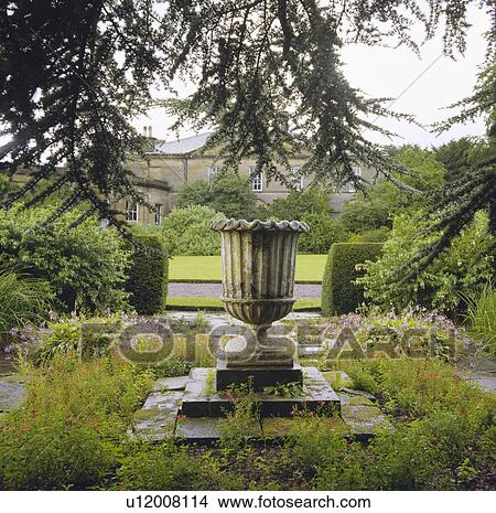 Picture - Stone urn in large country garden. Fotosearch