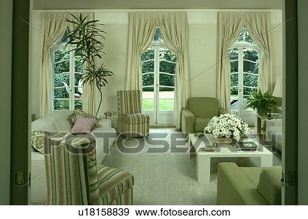 Stock Photo - Striped chairs and cream curtains in traditional living room. Fotosearch
