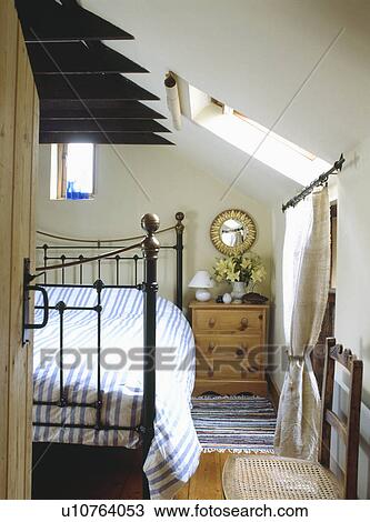 Striped duvet on brass bed in attic cottage bedroom View Large Photo Image Stock Image - Striped duvet on brass bed in attic cottage bedroom. Fotosearch