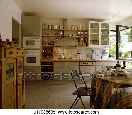 Striped tablecloth and metal chair in modern kitchen with white floor tiles View Large Photo Image Stock Photography - Striped tablecloth and metal chair in modern kitchen with white floor tiles. Fotosearch