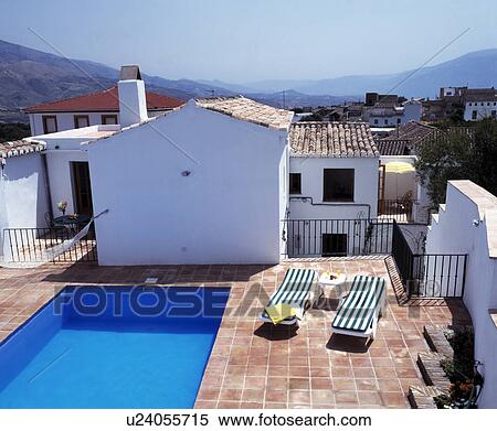 Stock Photography - Swimming pool in front of large villa in southern Spain. Fotosearch