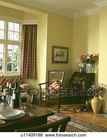 Pictures Of Table Set For Lunch In Pale Yellow Dining Room With Picture Table Set For Lunch In Pale Yellow Dining Room With Patterned Red Curtains And