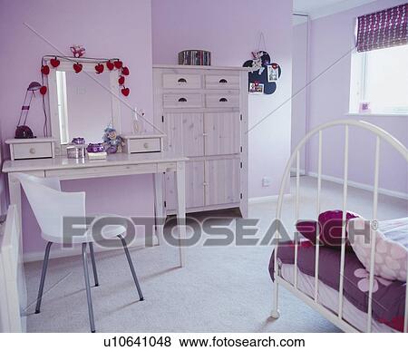 Stock Photo - Teenager's pink bedroom with dressing table . Fotosearch