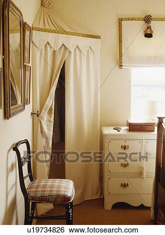 Tented Fabric Storage Cupboard In Corner Of Bedroom With Antique
