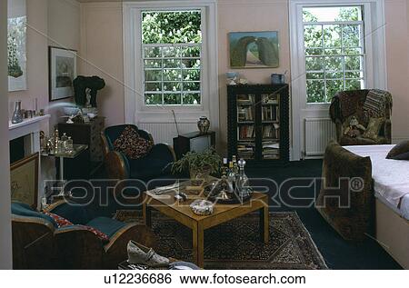 Thirties armchairs and table in sixties bedroom View Large Photo Image Stock Photograph - Thirties armchairs and table in sixties bedroom. Fotosearch