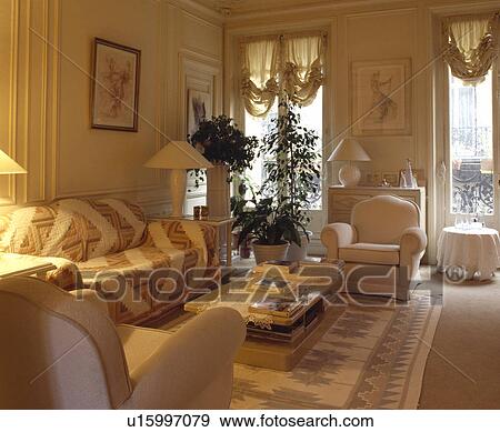 Throw on sofa in traditional living room View Large Photo Image Stock Photo - Throw on sofa in traditional living room. Fotosearch