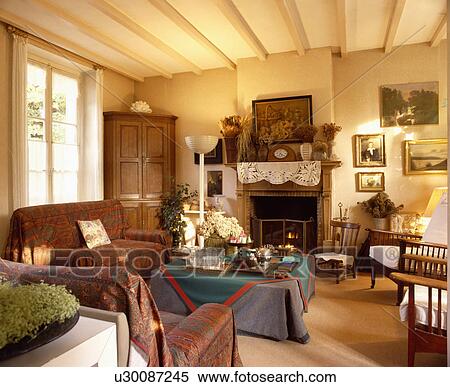 Throw on sofa in traditional living room View Large Photo Image Stock Photography - Throw on sofa in traditional living room. Fotosearch