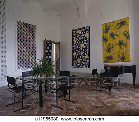 Tiled floor and large pictures on walls in white dining room with piano and modern black chairs with glass table View Large Photo Image Stock Image - Tiled floor and large pictures on walls in white dining room with piano and modern black chairs with glass table. Fotosearch