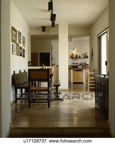 Tiled floor in openplan dining room with antique wooden bench and chairs View Large Photo Image Stock Photo - Tiled floor in openplan dining room with antique wooden bench and chairs . Fotosearch