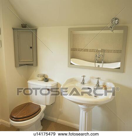 Stock Photograph Of Toilet And Pedestal Basin Below Mirror In Stock Photograph Toilet And Pedestal Basin Below Mirror In Traditional Cream Bathroom Fotosearch