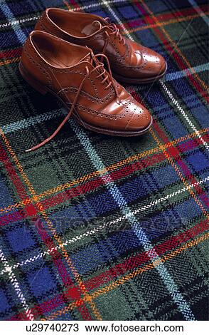 Traditional brown mens shoes on tartan carpet View Large Photo Image Stock Image - Traditional brown mens shoes on tartan carpet. Fotosearch