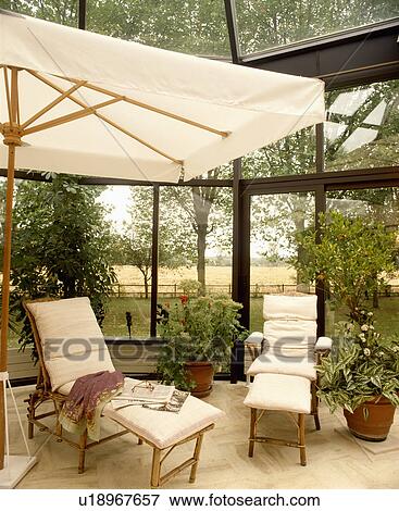 Traditional conservatory living room with comfortable furniture and green plants View Large Photo Image Stock Photo - Traditional conservatory living room with comfortable furniture and green plants. Fotosearch