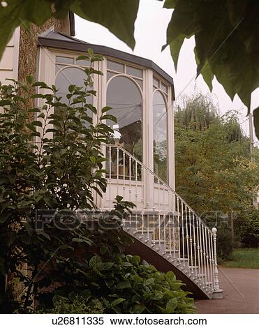 Stock Photography - Traditional country house in France with staircase to conservatory. Fotosearch