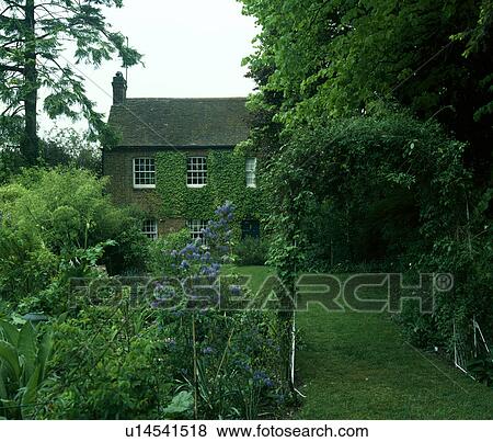 Traditional house in the country with trees and shrubs around the lawn View Large Photo Image Stock Photo - Traditional house in the country with trees and shrubs around the lawn. Fotosearch