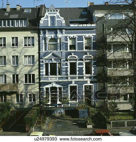 Stock Image - Traditional large blue terraced town house in German. Fotosearch