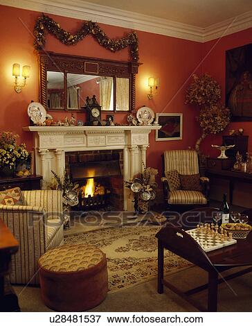 Stock Photo - Traditional red living room decorated for Christmas. Fotosearch