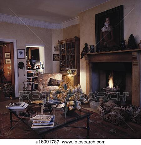 Traditional town living room with lighted fire in fireplace View Large Photo Image Stock Photo - Traditional town living room with lighted fire in fireplace. Fotosearch
