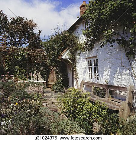 Stock Photography - Traditional white country cottage. Fotosearch