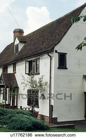 Stock Photograph - Traditional white country house with pargetting on walls. Fotosearch