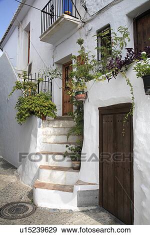 Traditional white Spanish house with steps leading up to front door View Large Photo Image Stock Photo - Traditional white Spanish house with steps leading up to front door . Fotosearch
