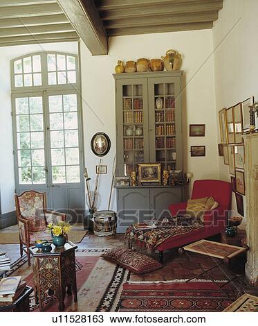 Stock Image - Upholstered chaiselongue in traditional living room. Fotosearch