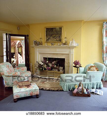 Stock Image - Upholstered chaiselongue in traditional living room. Fotosearch