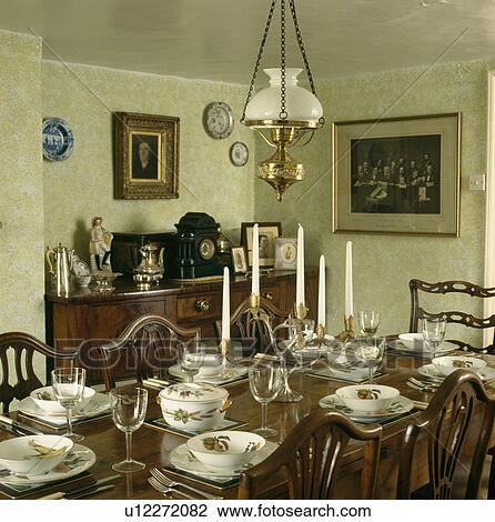 Victorian Style Lamp Over Antique Table With Fruit Patterned Crockery In Country Dining Room Victorian Style Lamp Over Antique Table With Fruit Patterned Crockery In Country Dining Room