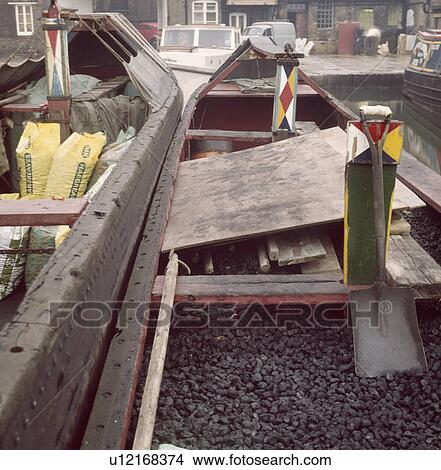 View of coal stored in prows of two traditional narrow boats on canal View Large Photo Image Picture - View of coal stored in prows of two traditional narrow boats on canal. Fotosearch