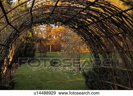 View of lawn though arch in country garden in Autumn View Large Photo Image Stock Photo - View of lawn though arch in country garden in Autumn. Fotosearch