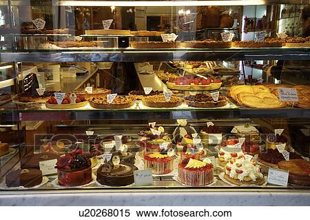 Stock Photography - View of shelves of French patisseries from outside the window of shop. Fotosearch