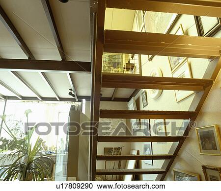View through wooden staircase in neutral hall View Large Photo Image Stock Image - View through wooden staircase in neutral hall. Fotosearch
