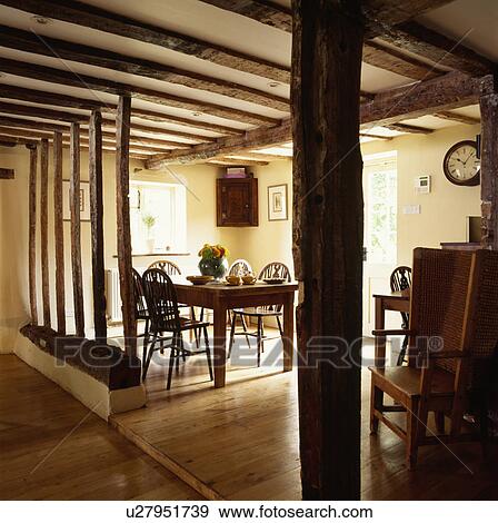 Stock Photo - Wall beams with plaster removed in country dining room with wooden flooring and beamed ceiling. Fotosearch