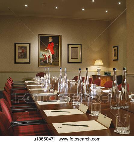 Stock Image - Well-lit modern designer decorated boardroom with built in monitor.. Fotosearch