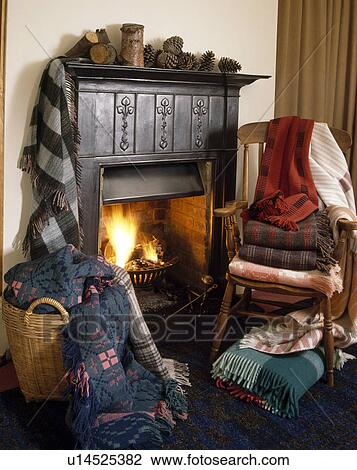 Welsh blankets in large basket beside fireplace and pile of blankets on wooden chair View Large Photo Image Stock Image - Welsh blankets in large basket beside fireplace and pile of blankets on wooden chair. Fotosearch