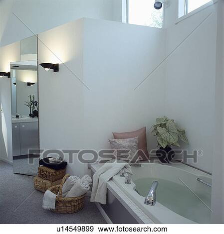 Stock Photo - White bathroom screened from bedroom by cupboards. Fotosearch