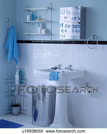 Stock Photography - White bathroom with tiled lower half and black tiled dado rail. Fotosearch