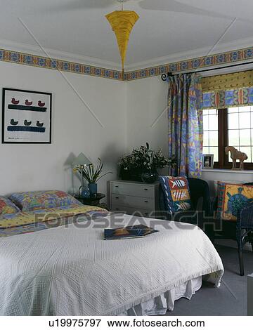 White Bedspread And Abstract Patterned Linen And Matching Curtains